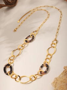 Detail of handmade leopard print long necklace with 18K gold plated links and resin rings