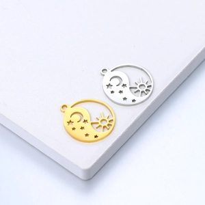 Detail of gold and silver sun moon star charms with intricate cutout craftsmanship