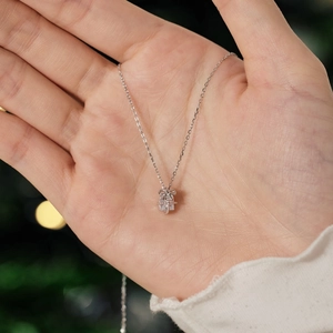 Close-up of S925 sterling silver necklace with a crystal-studded gift box pendant