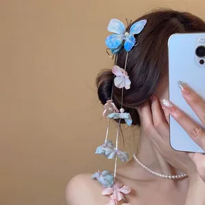 Elegant blue butterfly hair clip with long pearl tassels and pink fabric flower petals