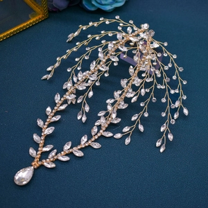 Detailed close-up of bridal headband featuring gold wires with marquise crystals and teardrop pendant