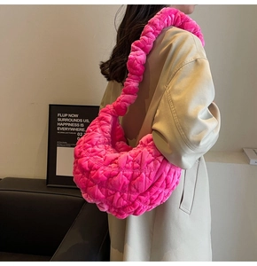 Detail of rose pink velvet cloud bag featuring soft pleated texture and shoulder strap