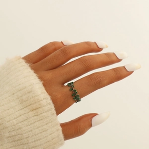 Close-up of a model wearing a green leaf design adjustable ring on her finger