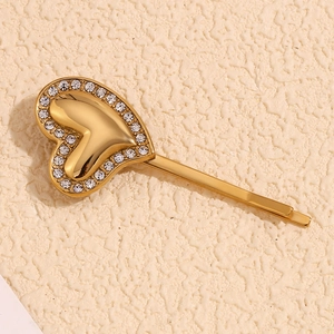 Close-up of heart-shaped hair clip with 18K gold plating and pavé rhinestones