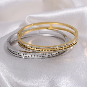 Titanium steel gear bracelets in gold and silver with double row diamonds on white satin