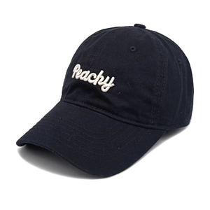 Close-up of a black cotton baseball cap featuring white Peachy cursive embroidery