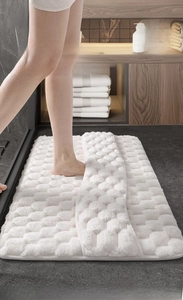 Detailed view of white 3D bubble texture memory foam bath mat with soft absorbent surface