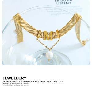 Detail of gold mesh choker with letter M pendant, teardrop pearl and MOM engraving