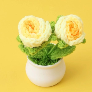 Handmade crochet rose plant with yellow-orange gradient flowers in a white ceramic pot
