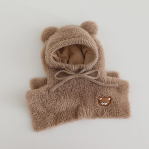 Close-up of soft camel plush bear ear hat with detailed embroidery and drawstrings