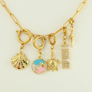Close-up of 18k gold plated necklace with shell, sea turtle and star moon charms