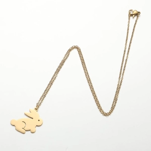 Macro shot of gold-plated rabbit pendant necklace with minimalist animal outline design