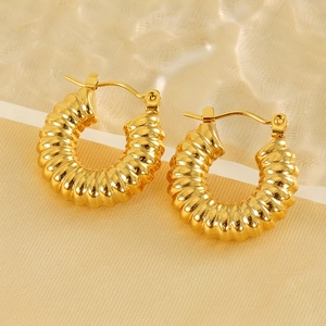18k gold plated stainless steel spiral hoop earrings on elegant silk background