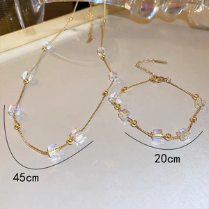 Detail view of gold sugar cube crystal necklace and bracelet with 45cm and 20cm measurements