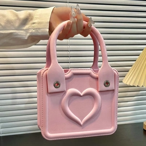 Detailed view of pink EVA beach bag featuring a 3D heart embossed pattern and soft handle