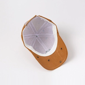 Overhead view of vintage retro kids baseball cap in tan with black polka dot brim detail