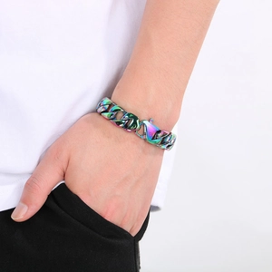 Detail of 15mm rainbow iridescent Cuban link chain bracelet on male model wrist