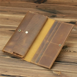 Macro detail of crazy horse leather wallet with multiple card slots and bronze snap button