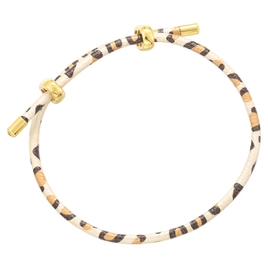 Close-up of leopard print bracelet with adjustable golden slide buckle and metal end caps