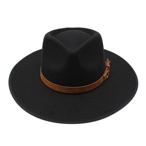 Detailed macro view of black felt fedora hat featuring a brown leather decorative band