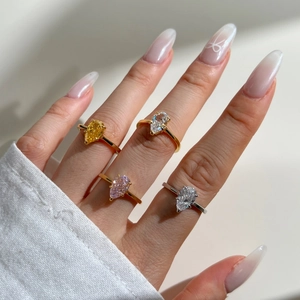 Close-up of S925 silver rings featuring pear-cut stones in yellow, pink, and white