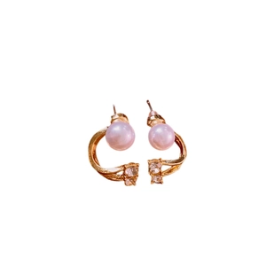 Elegant C-shaped gold-tone earrings with pink pearl and sparkling crystals on white background