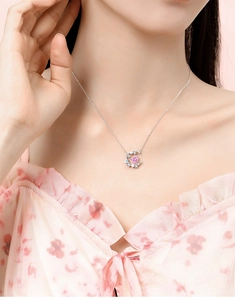 Detail of S925 silver necklace with pink heart zircon and crescent moon on model