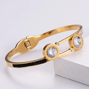 Detail of 18k gold plated titanium bracelet with black stones and Roman numerals