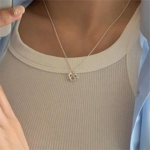 Minimalist 925 sterling silver heart knot pendant necklace on a delicate silver chain