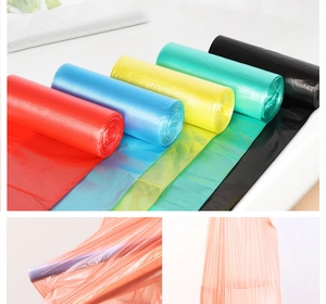 Detail view of multi-colored thick plastic garbage bag rolls in flat-mouth design