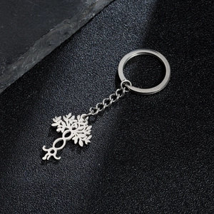 Silver tree of life keychain with hollow metal pendant on a premium black background