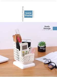 Minimalist white hollow-grid desk organizer storage box holding office supplies on wood table