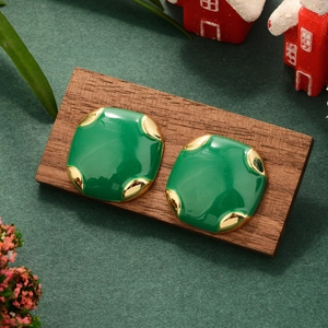 Vintage style square green enamel earrings with 14K gold plated borders on a wooden stand