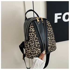 Close-up of leopard print fabric and black PU leather detail on a stylish mini backpack