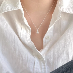 Elegant 925 sterling silver pearl pendant necklace worn on a casual white shirt