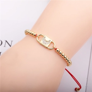 Adjustable red string bracelet with gold bead lock charm and moon-shaped zircon inlay