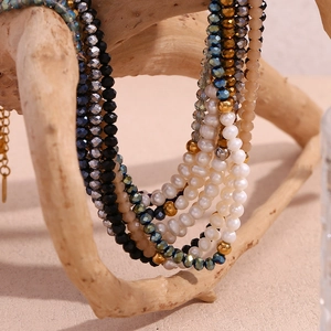 Detailed macro view of freshwater pearls and faceted black crystal beads on gold-plated chain