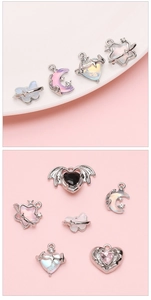 Macro detail of alloy pendants featuring moon, butterfly and heart shapes for DIY jewelry