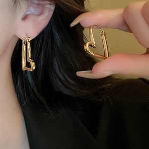 Elegant gold hollow heart earrings for women featuring a minimalist polished metal design