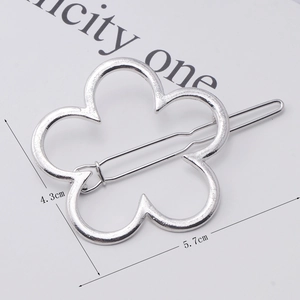 Macro view of silver floral contour hair clip with size dimensions 5.7cm by 4.3cm