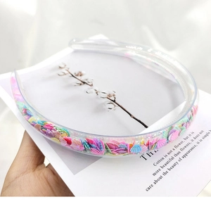 Detail of transparent PVC headband with colorful shell sequins and anti-slip inner teeth
