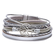 Detailed shot of multi-layer braided silver leather bracelet with Tree of Life charm