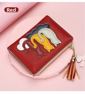 Red PU leather wallet with lychee texture featuring cat appliques and colorful tassels