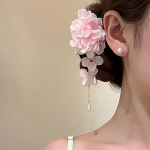 Detail of pink fabric flower hair clip with hanging pearl tassels and golden chains