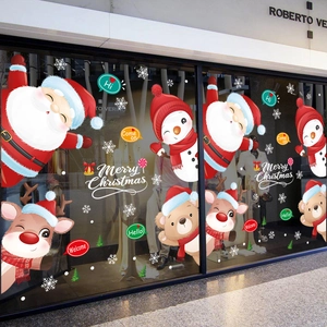 Stickers de Noël pour vitrine avec Père Noël et renne sur une façade en verre