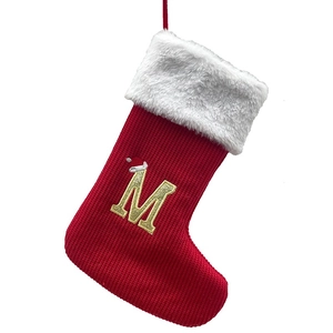 Red knitted Christmas stocking with white faux fur trim and gold embroidered letter M