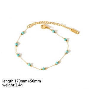 Detailed close-up of gold stainless steel anklet with turquoise beads and size labels