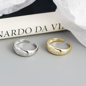 Detailed shot of S925 silver and gold celestial rings with star and moon engravings