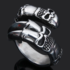 Macro shot of vintage silver double skull ring with intricate Nordic rune detailing