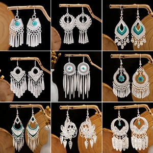 Ethnic bohemian silver tassel earrings set with turquoise beads and mandala patterns